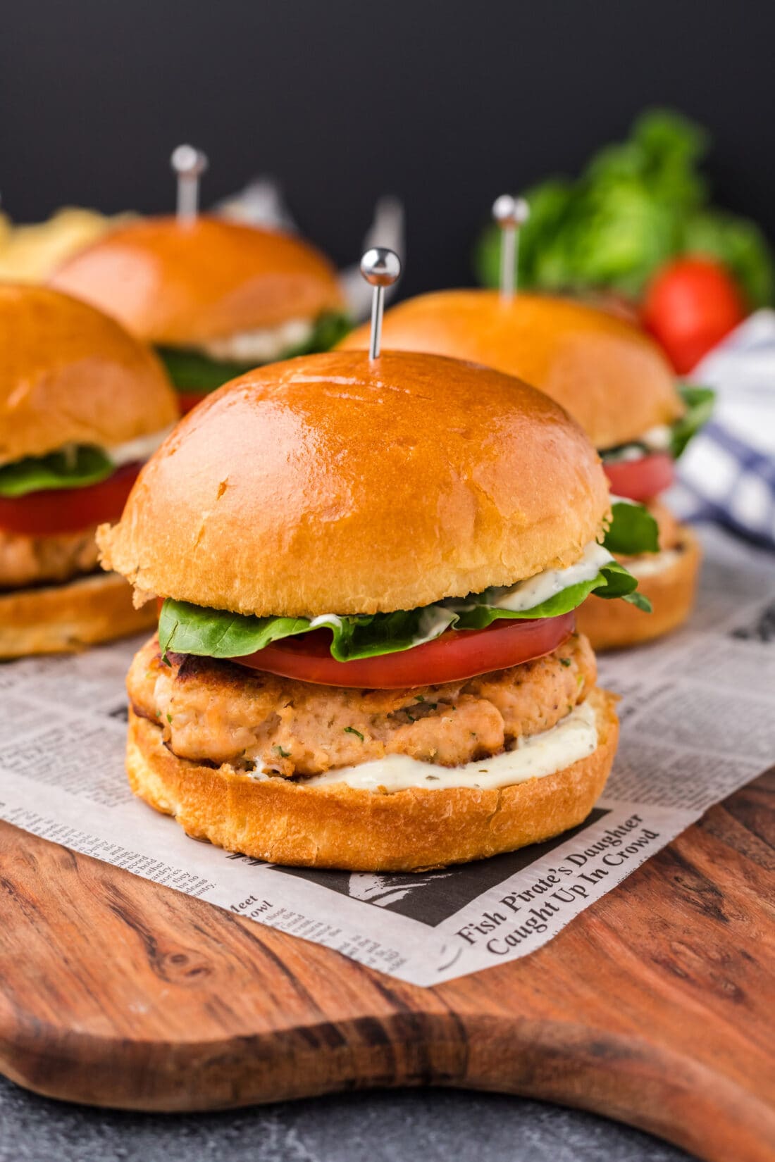 Close up photo of Salmon Burgers on a wooden platter