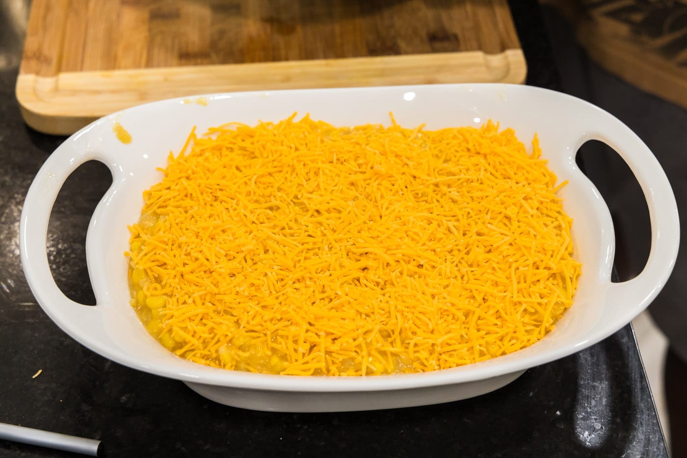 cheese added on top of scalloped corn casserole