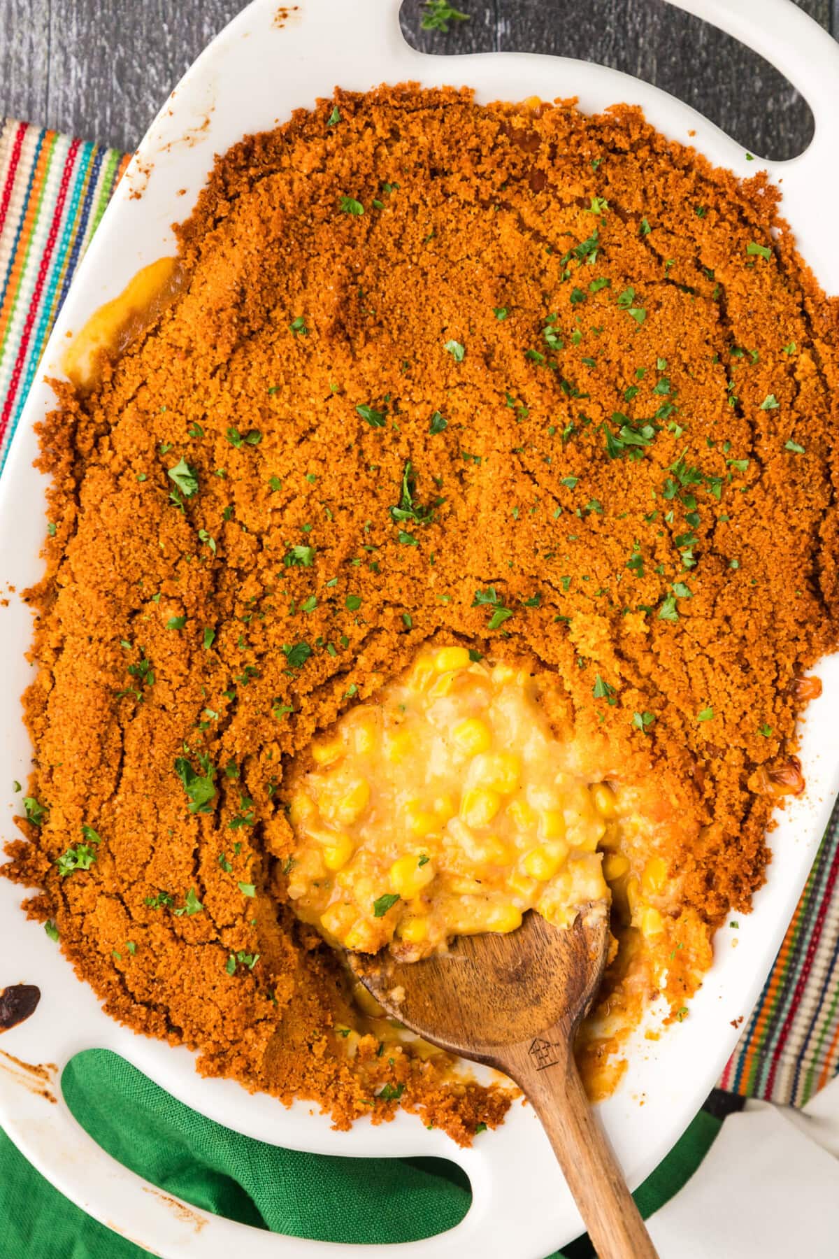 Pan of Scalloped Corn with a serving spoon in it