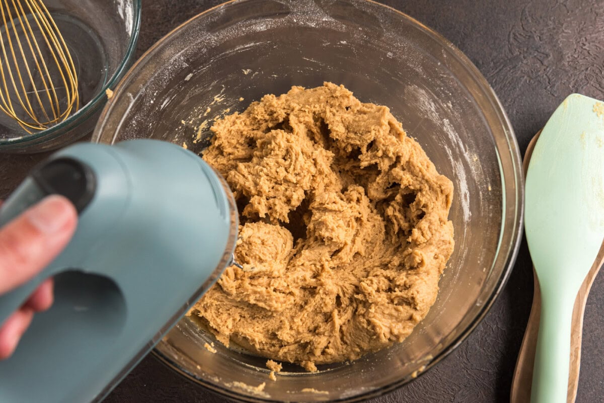 mixing peanut butter cookie dough with an electric mixer