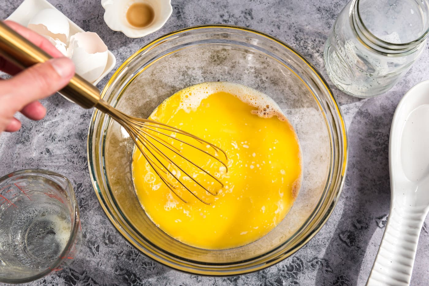 whisking egg and milk mixture in a bowl