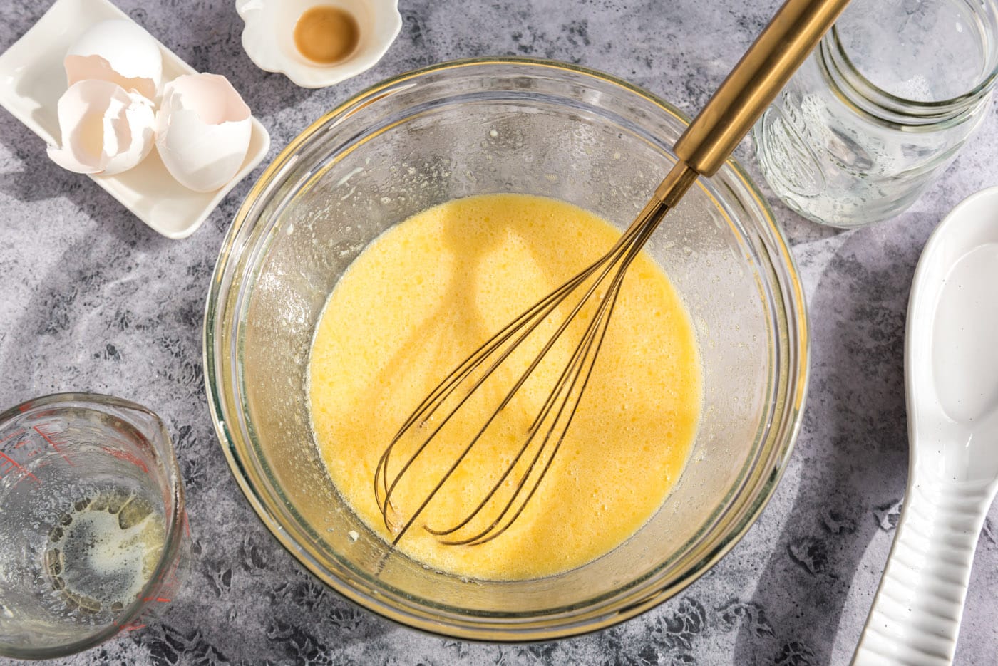 whisked egg and milk mixture for muffins in a bowl