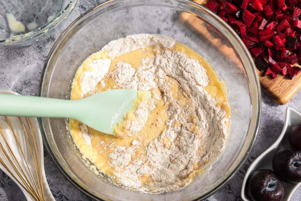 rubber spatula combining wet and dry ingredients for muffins