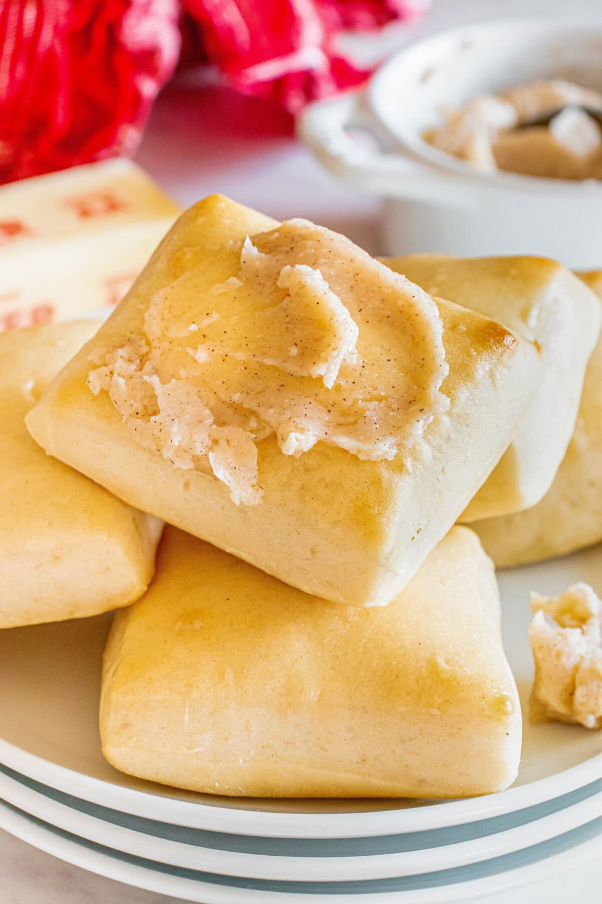 Close up photo of a Texas Roadhouse Roll topped with butter