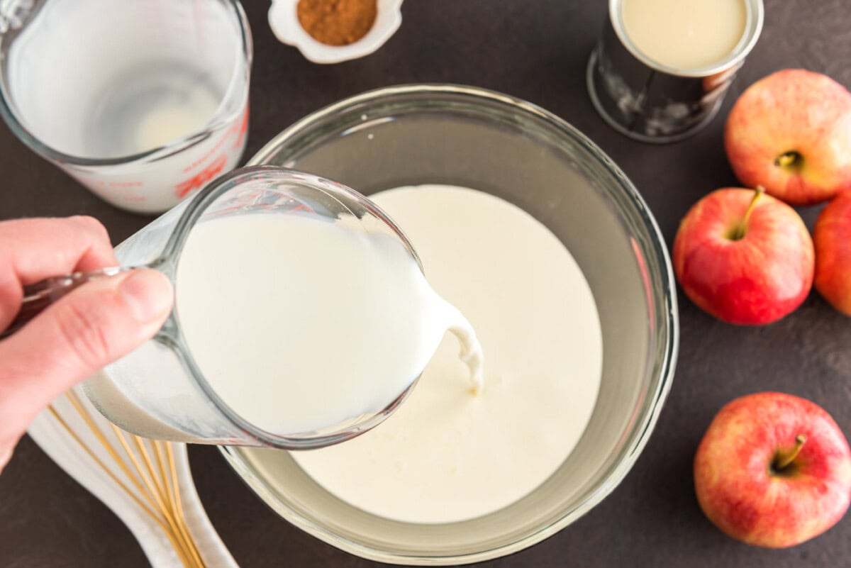 pouring heavy cream into bowl
