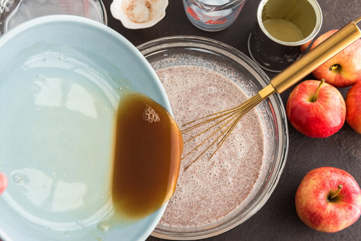 pouring apple cider into cinnamon and cream mixture