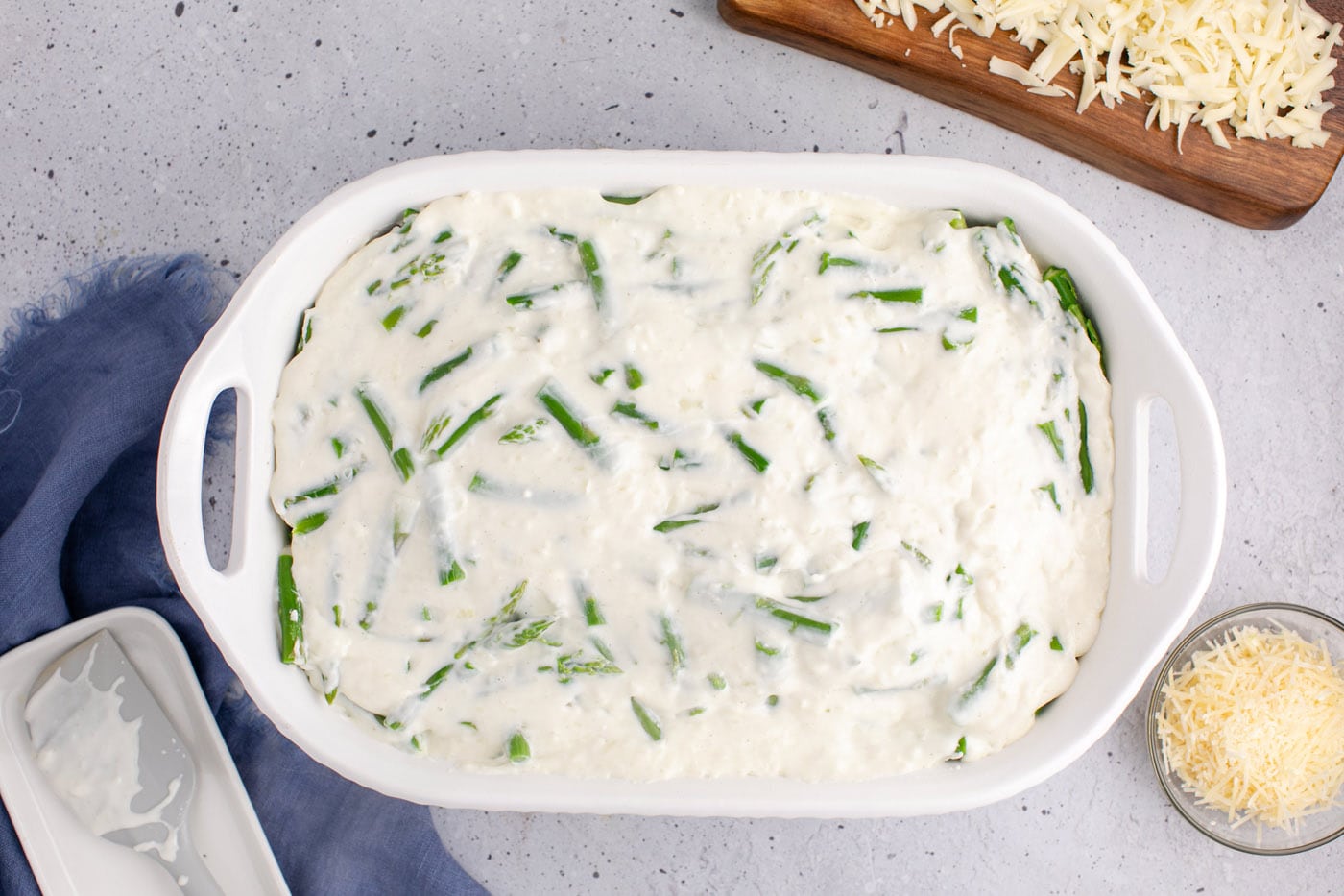 cheese sauce added to casserole dish of asparagus
