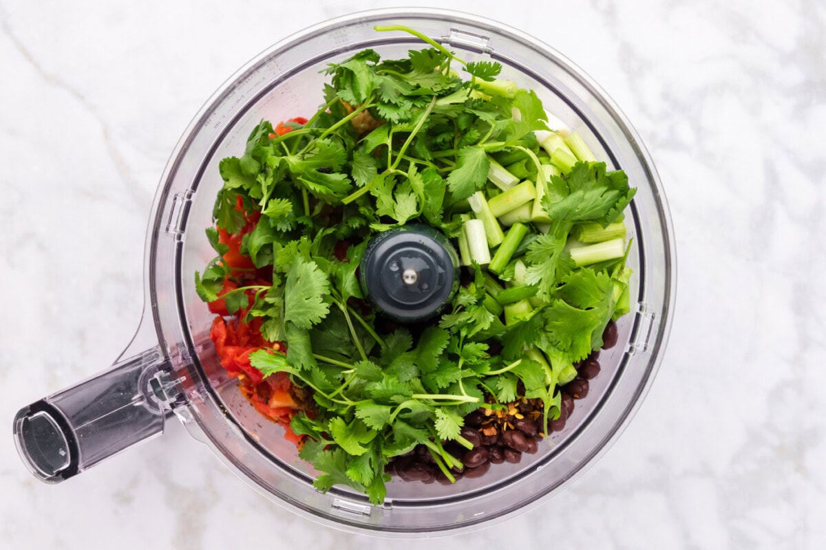 adding cilantro to dip in food processor