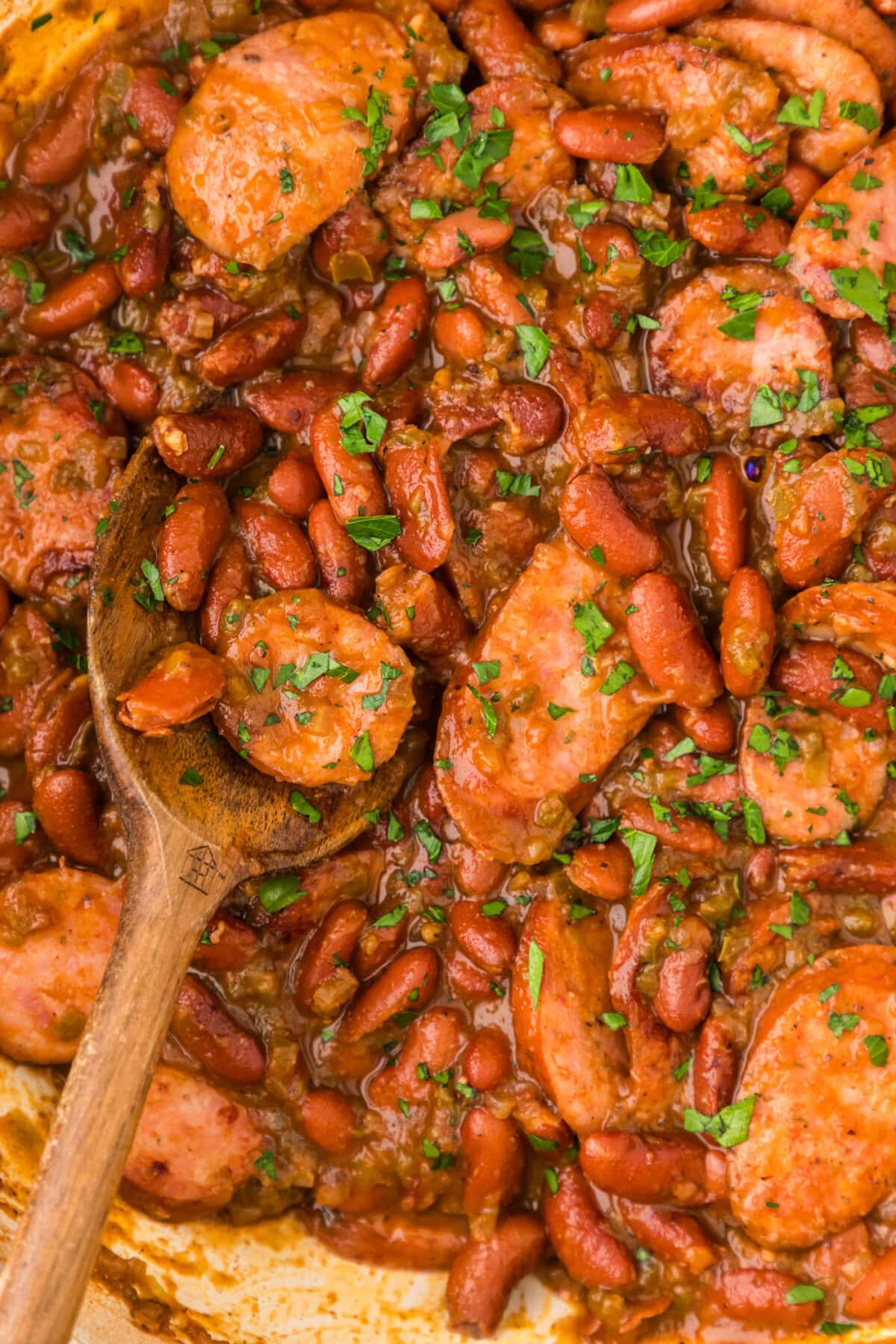 Close up photo of Cajun Red Beans in a skillet with a spoon