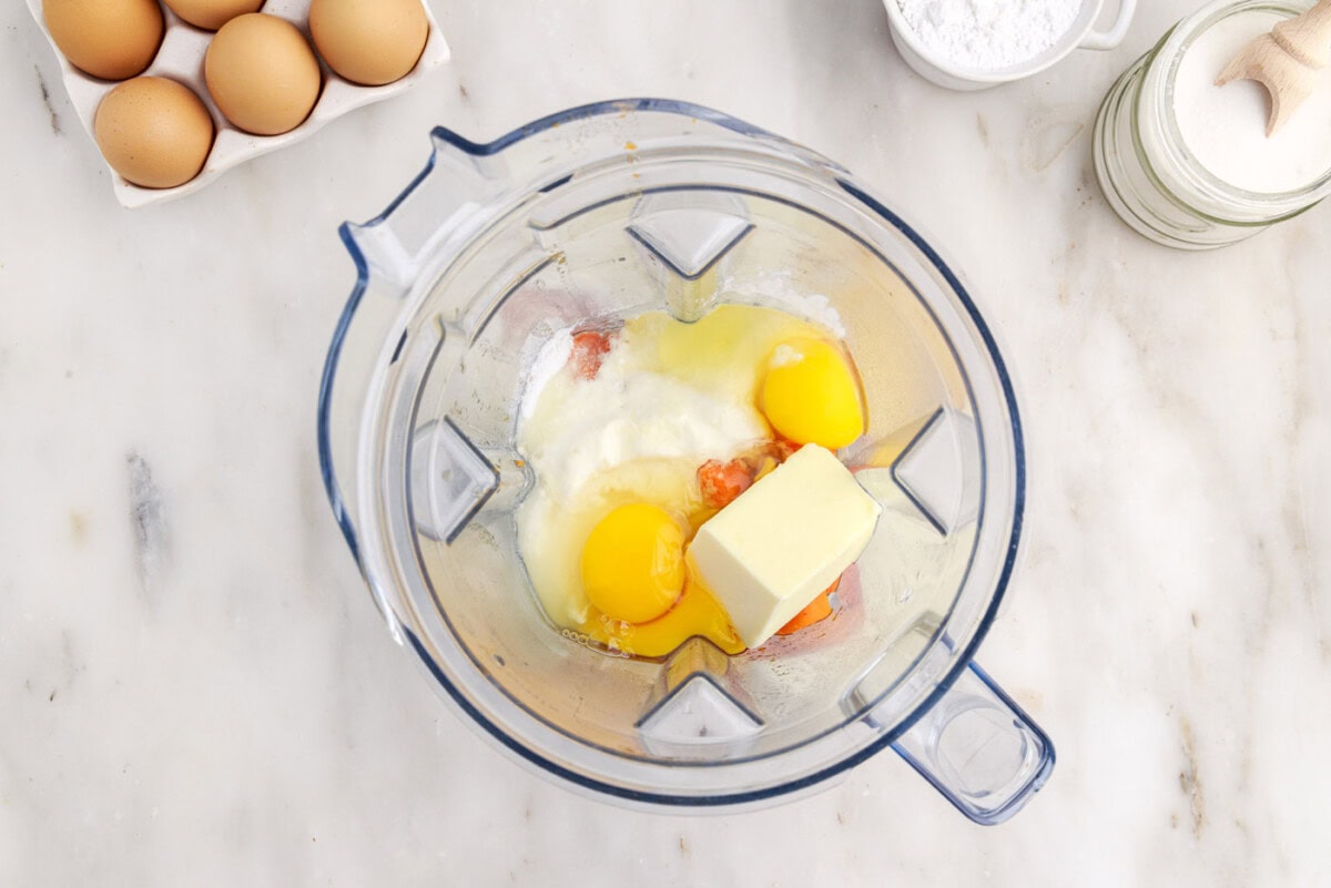 souffle ingredients with carrots in a blender bowl