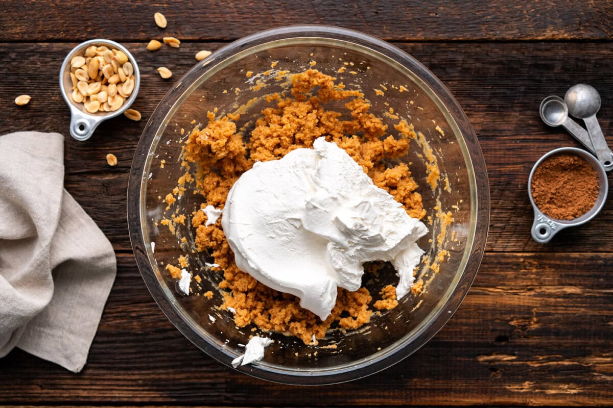 adding cool whip to peanut butter pie filling