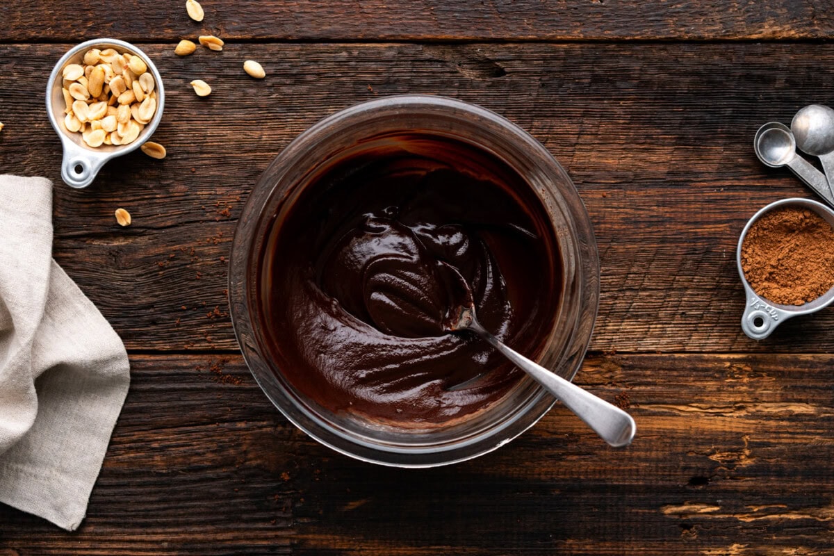 chocolate ganache in a mixing bowl with a spoon