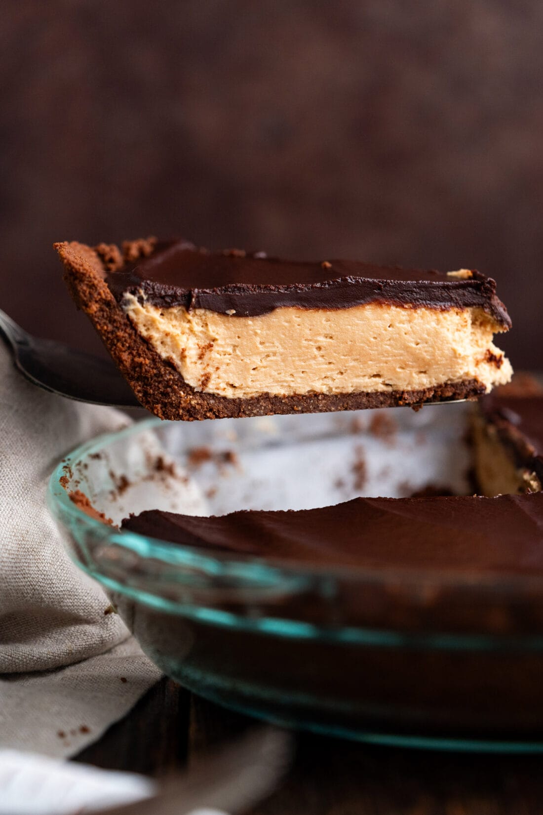 Slice of Chocolate Peanut Butter Pie being lifted out of the pie dish