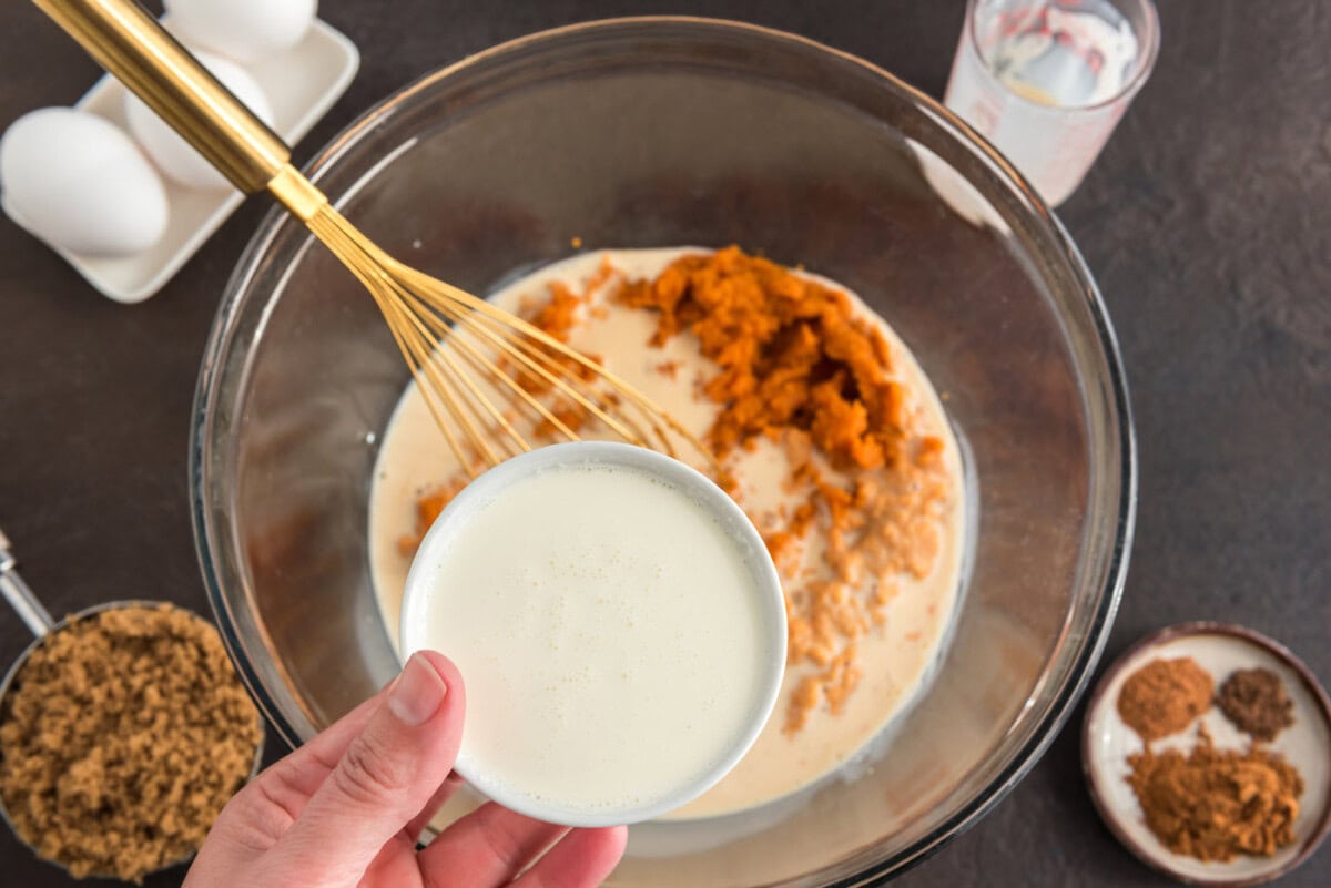 combining pumpkin pie ingredients in a bowl