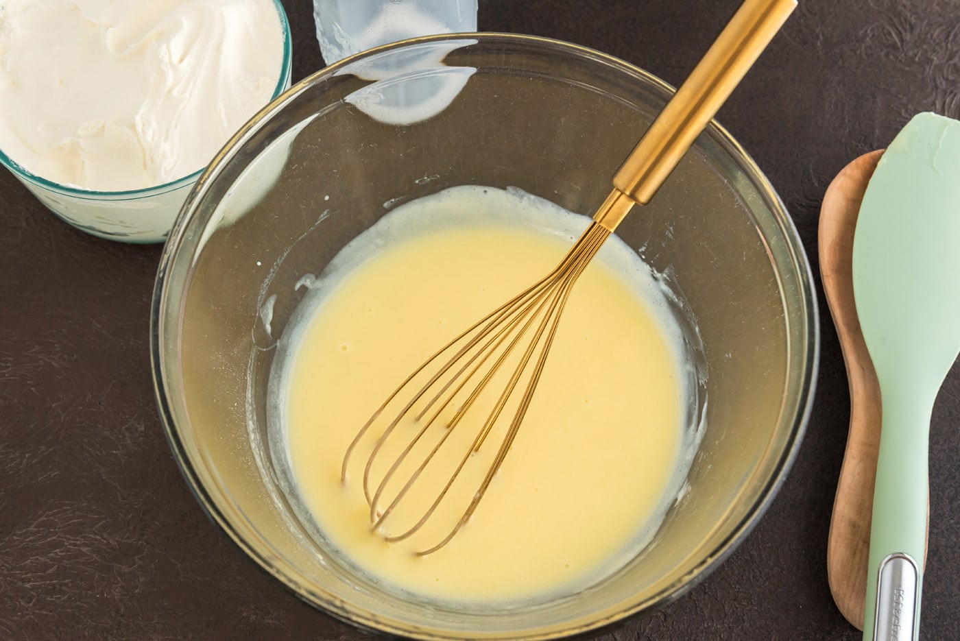 vanilla instant pudding in a bowl with a whisk