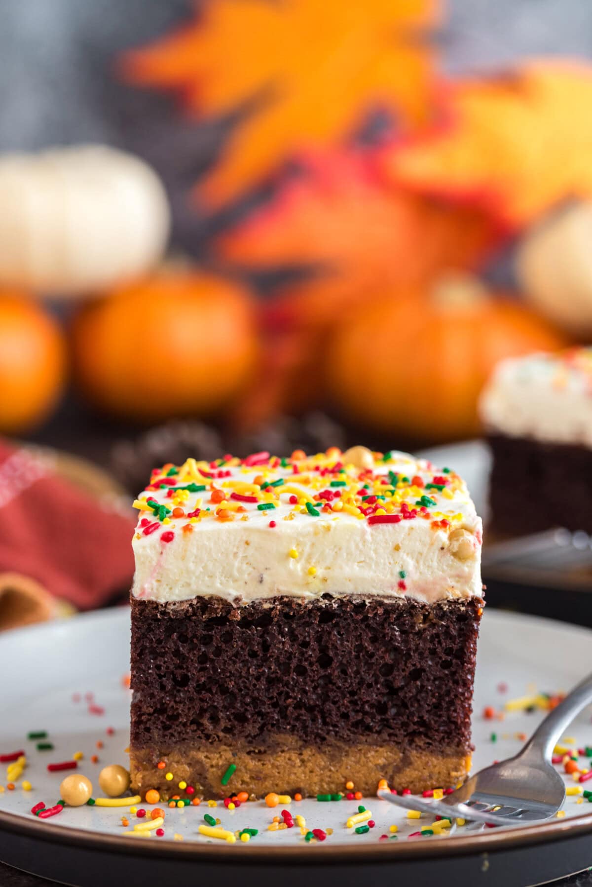 Square piece of Chocolate Pumpkin Magic Cake on a plate with a fork