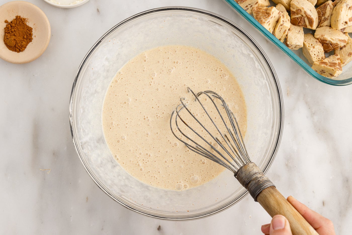 cinnamon roll filling ingredients in a bowl with a whisk