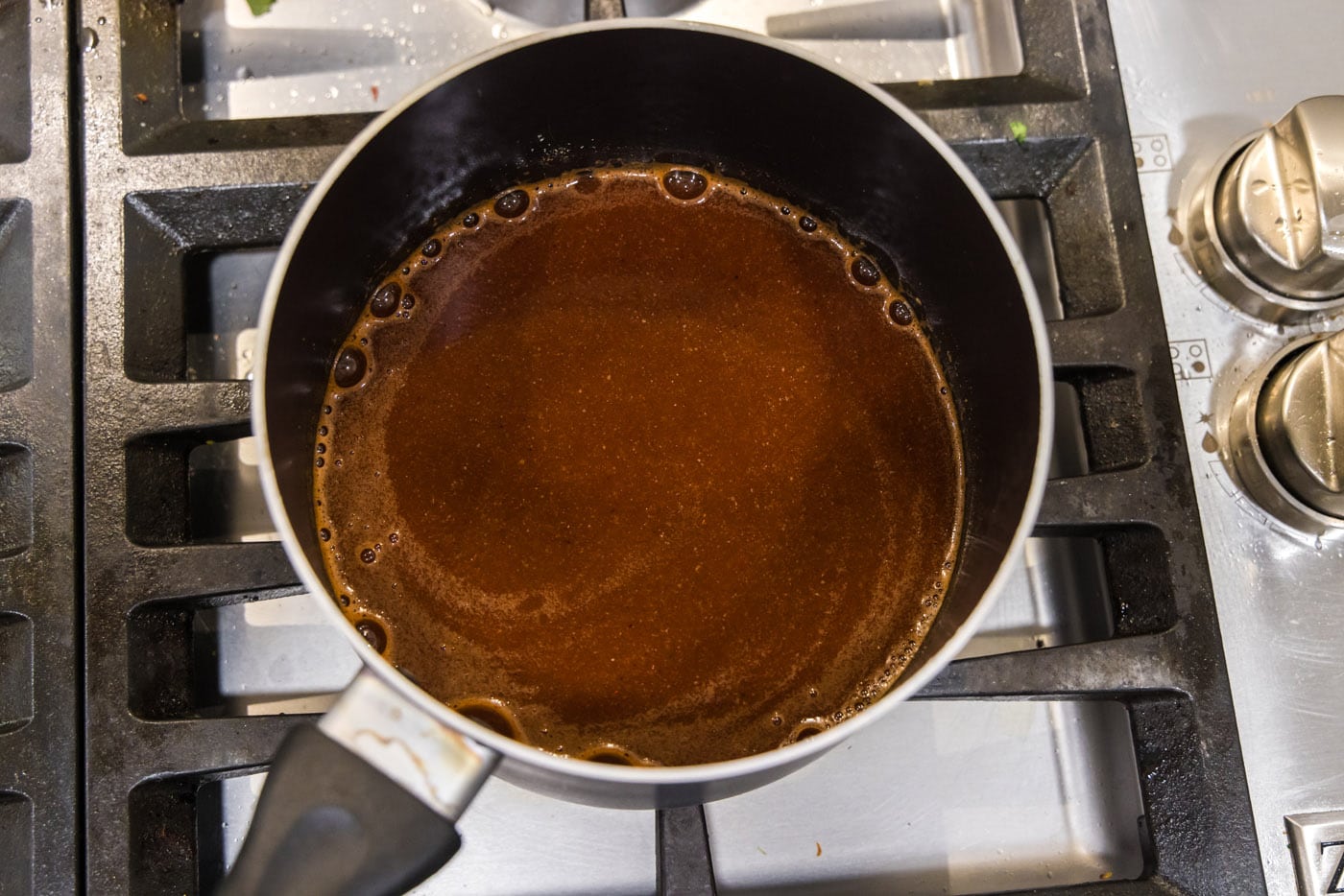 dr. pepper barbecue sauce cooking on the stovetop