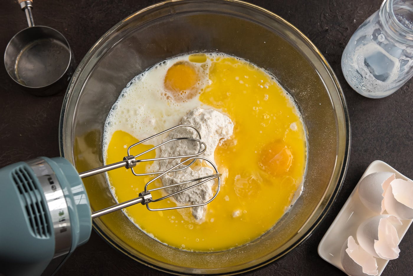 mixing cake mix and ingredients with a hand mixer