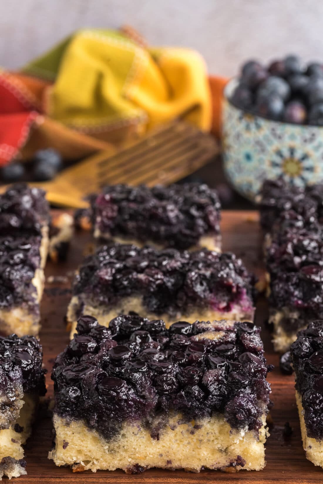 Easy Blueberry Upside Down Cake cut into squares on a wooden board