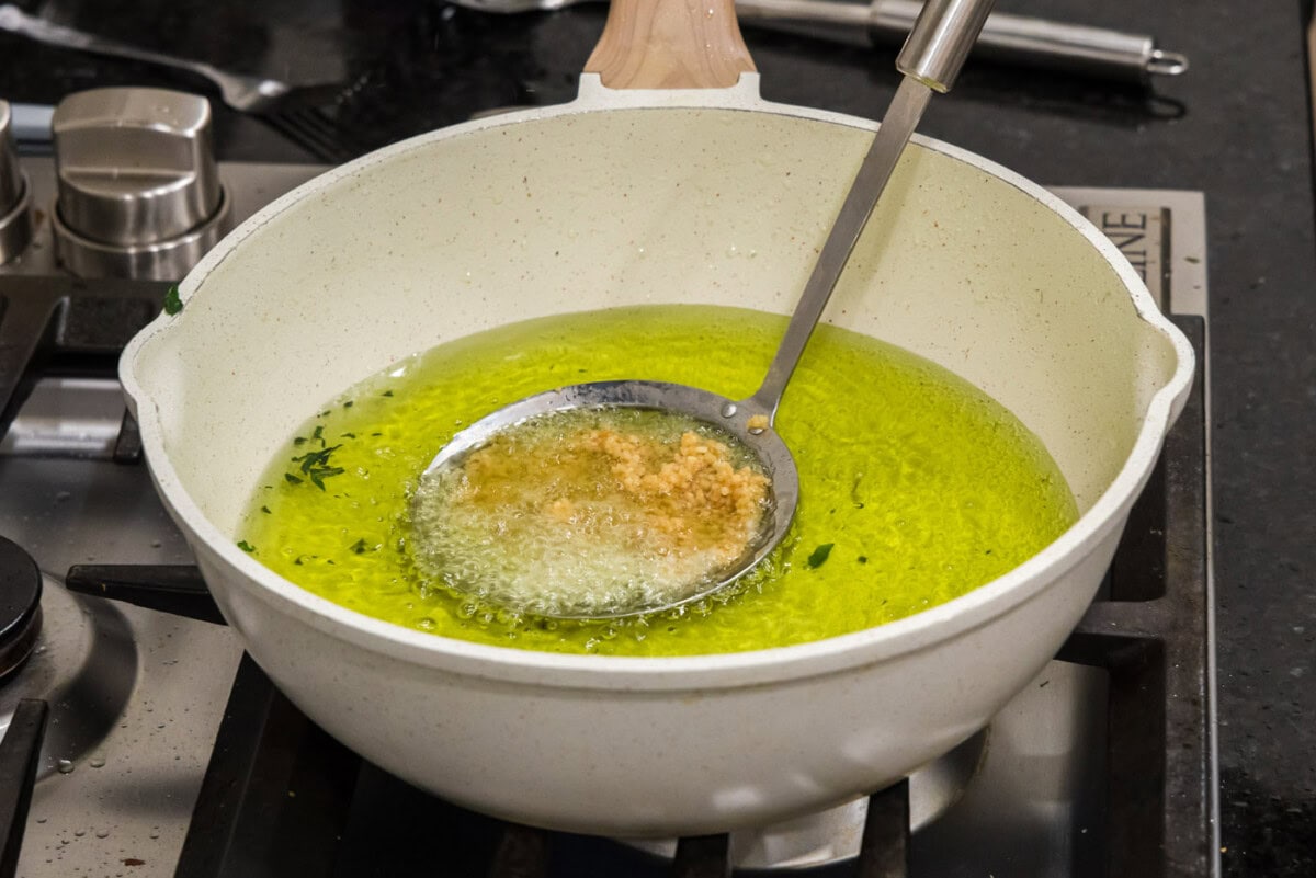 fat skimmer removing fried garlic from oil