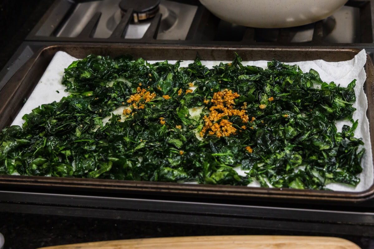 garlic on top of fried spinach