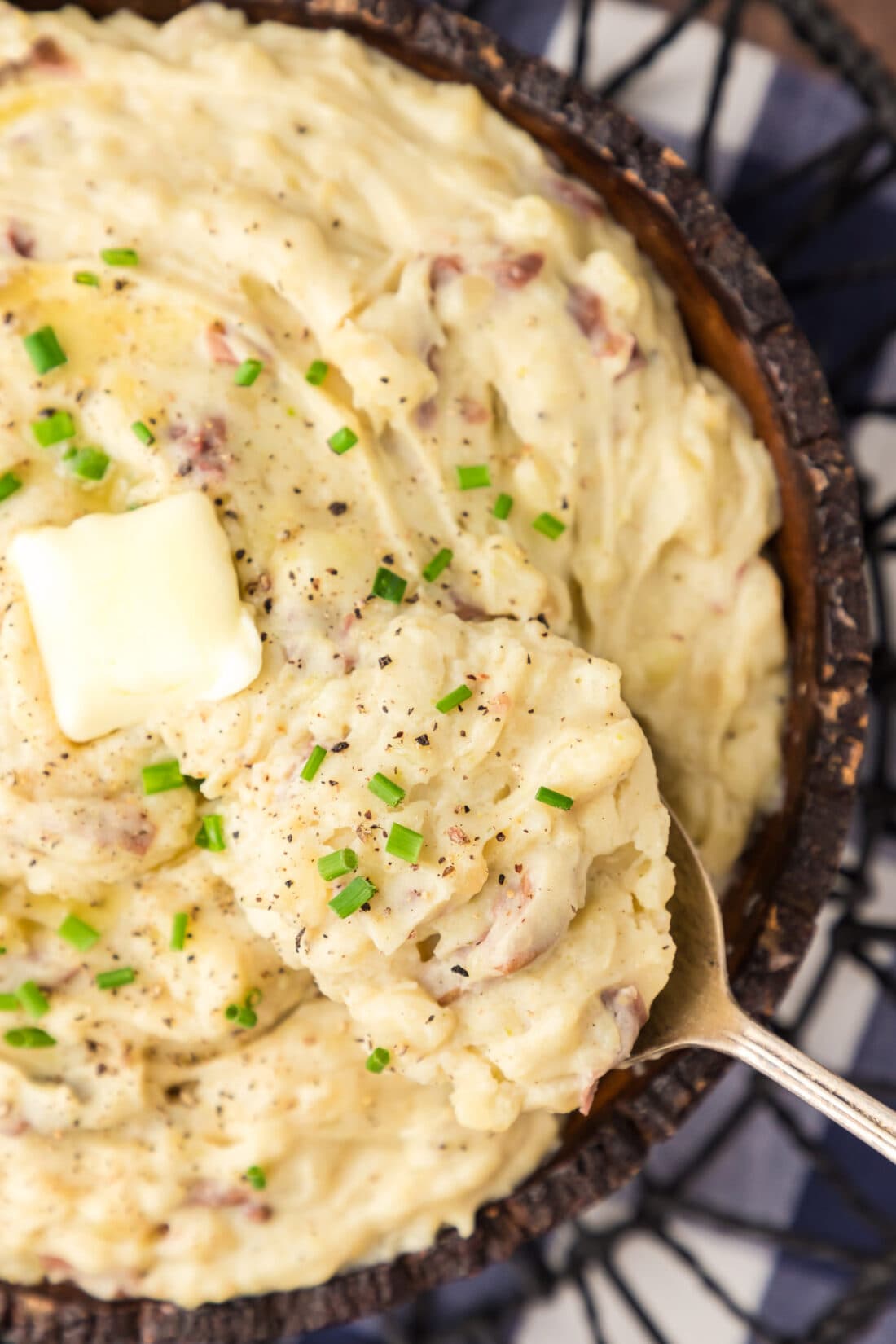 Close up photo of a spoon in a bowl of Garlic Mashed Potatoes