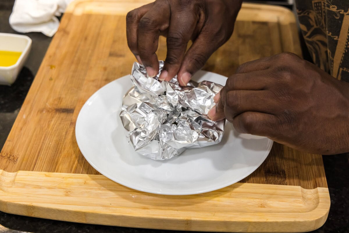 closing aluminum foil around garlic bulbs