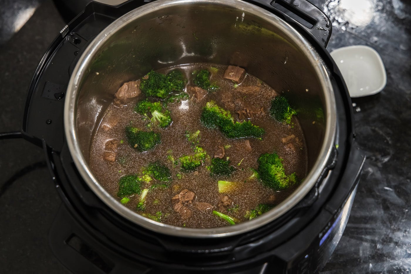 beef and broccoli mixture in the pressure cooker