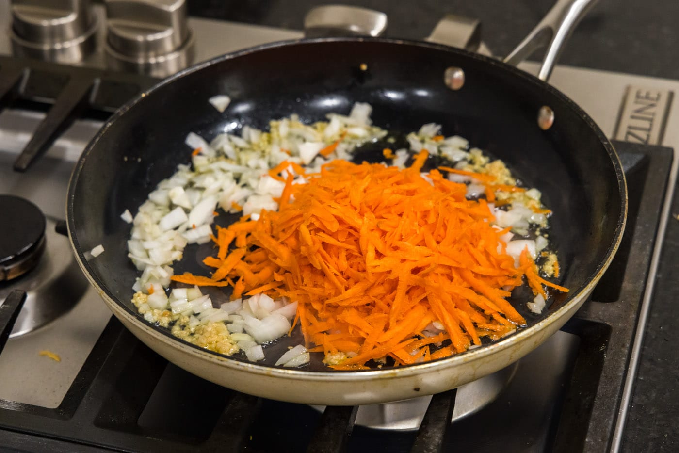 garlic, onion, and carrot added to skillet