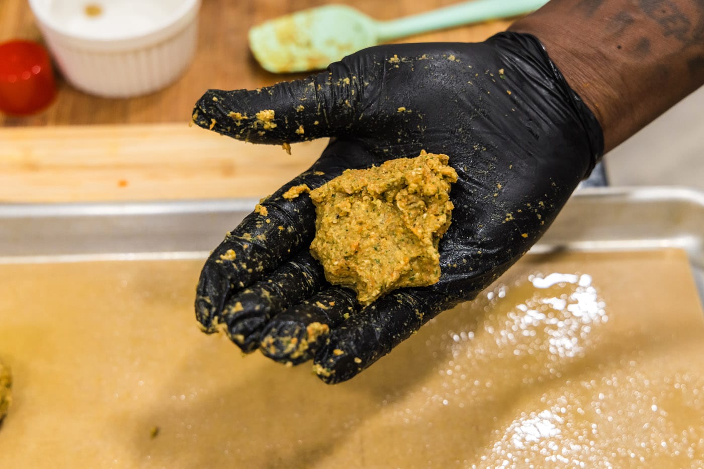 lentil meatball mixture in palm of hand