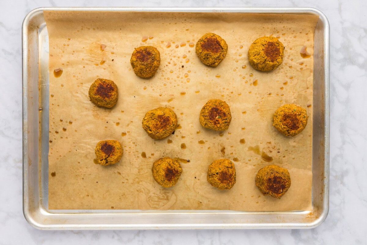 baked lentil meatballs on a cookie sheet