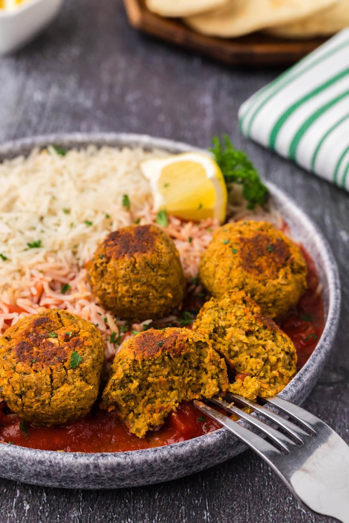 Close up photo of a Lentil Meatball split in half with a fork