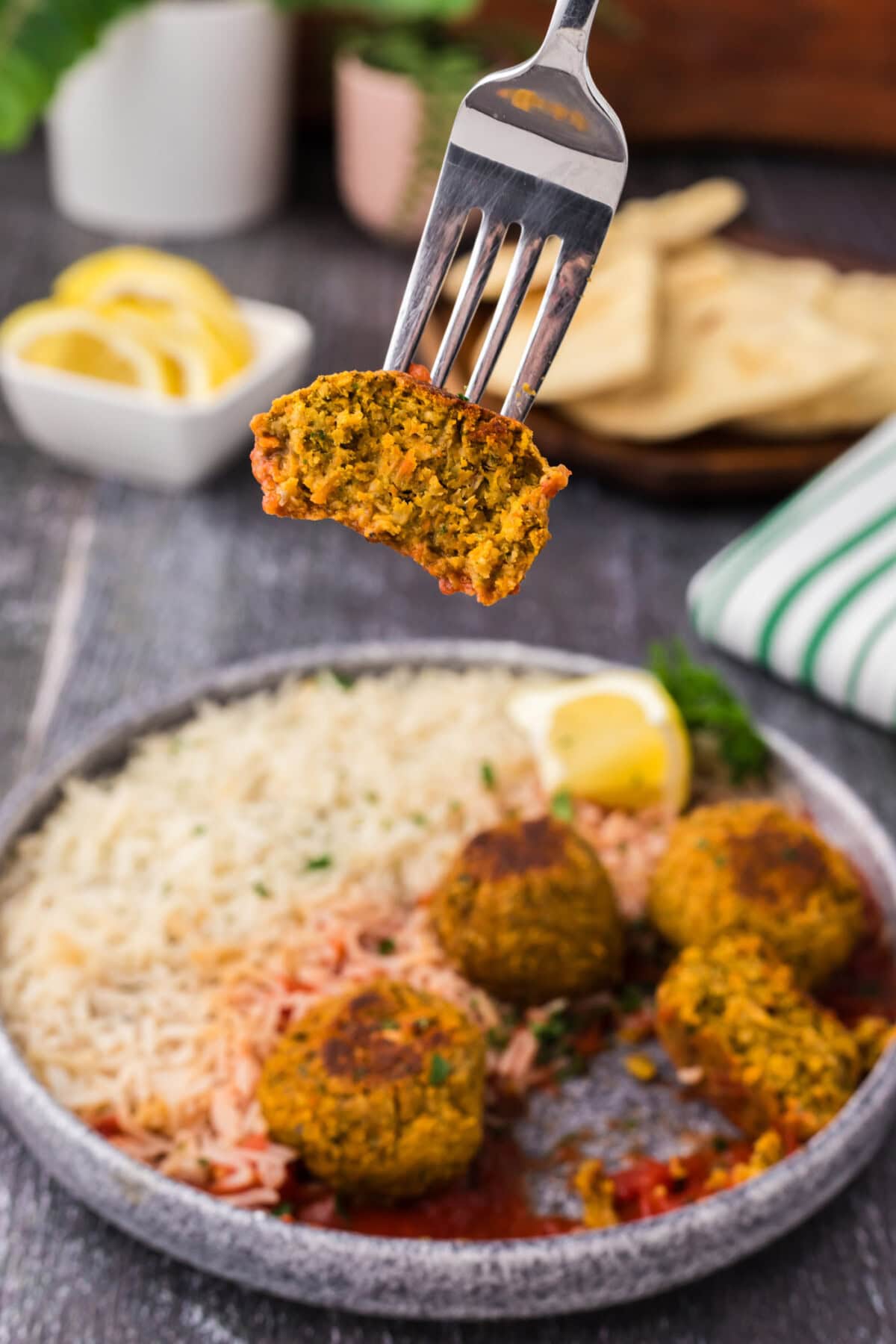 Half of a Lentil Meatball lifted by a fork