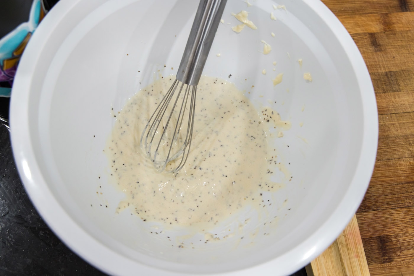 lobster salad dressing ingredients in a bowl with a whisk
