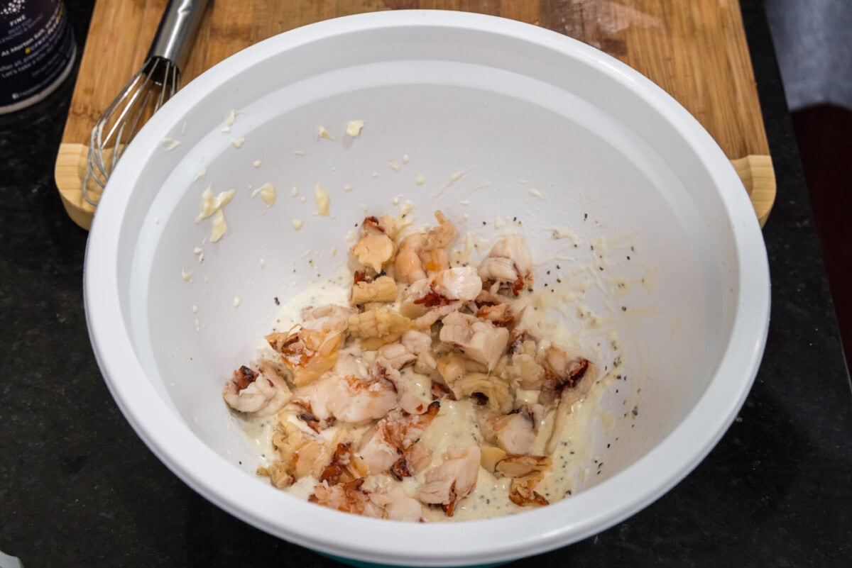 chopped lobster meat added to bowl of dressing