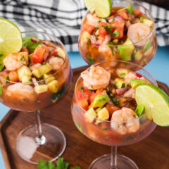 Three Mexican Shrimp Cocktails on a wood serving tray
