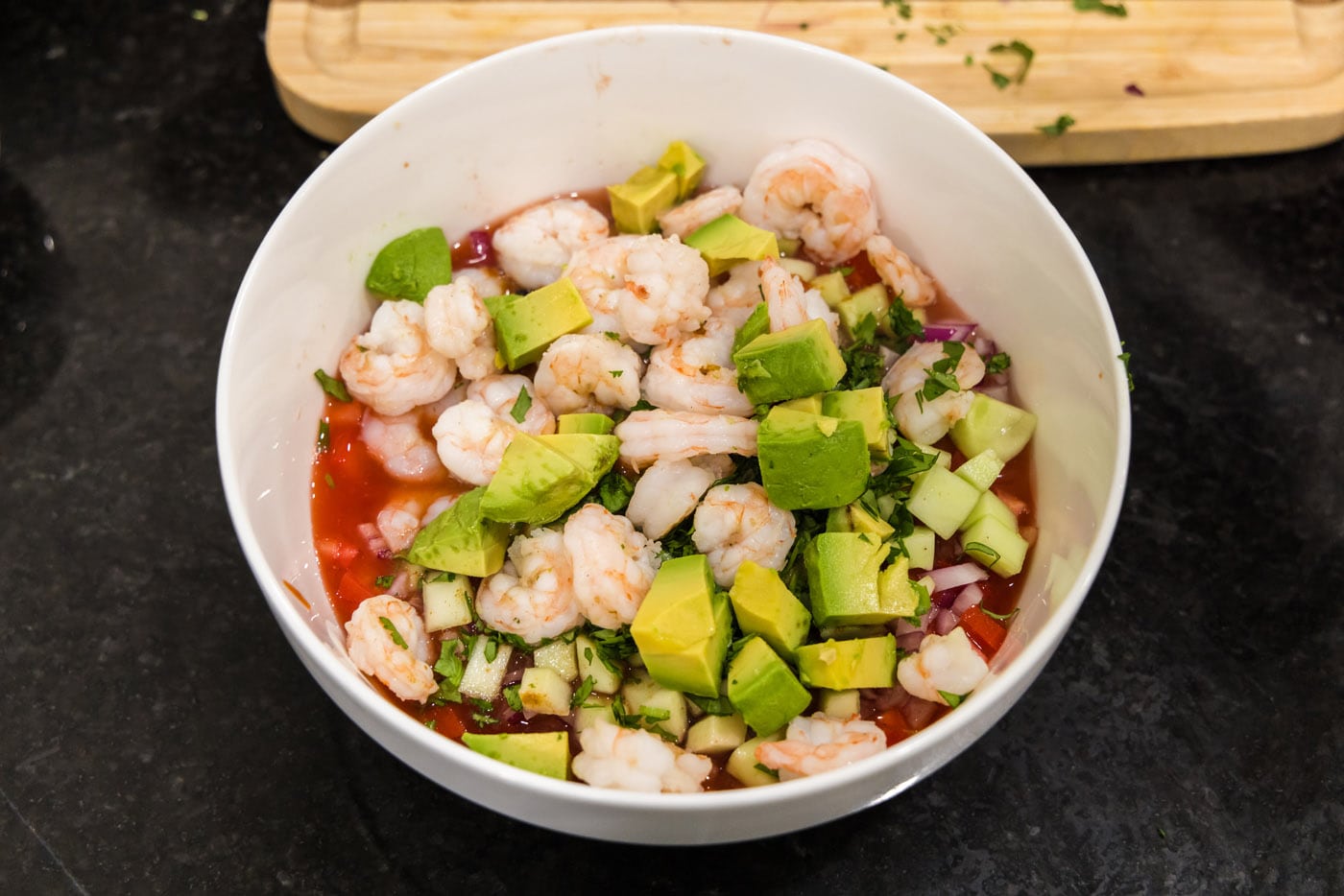chopped avocado and cooked shrimp added to mexican shrimp cocktail ingredients