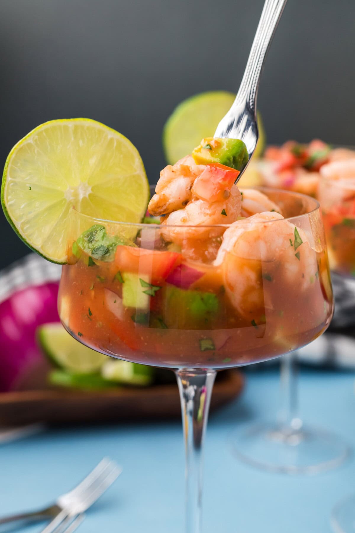 Close up photo of a Mexican Shrimp Cocktail with a fork in it