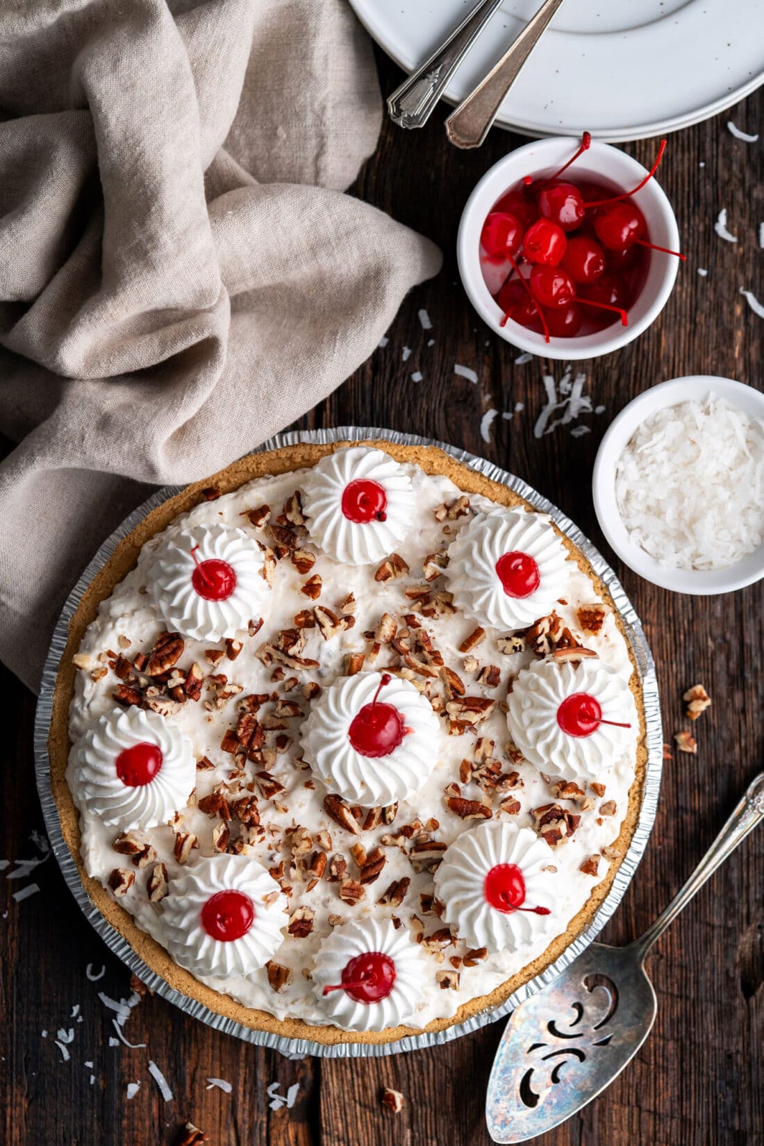 Million Dollar Pie with a bowl of cherries and shredded coconut on the side