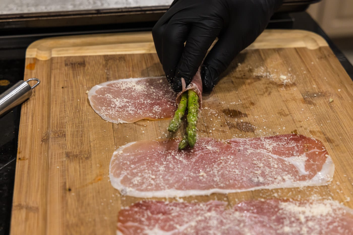 rolling asparagus spears in prosciutto