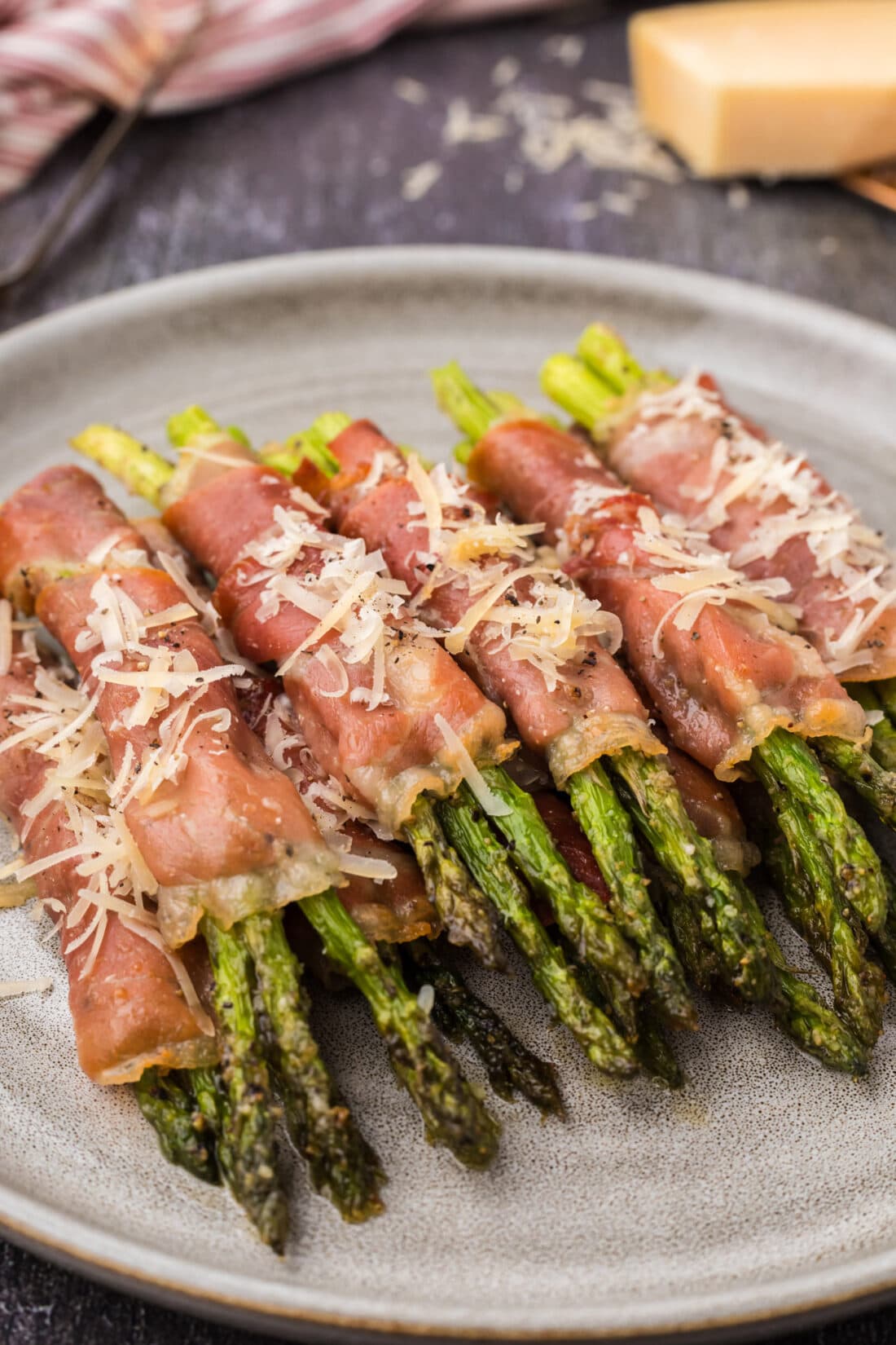 Prosciutto Wrapped Asparagus stacked on a plate