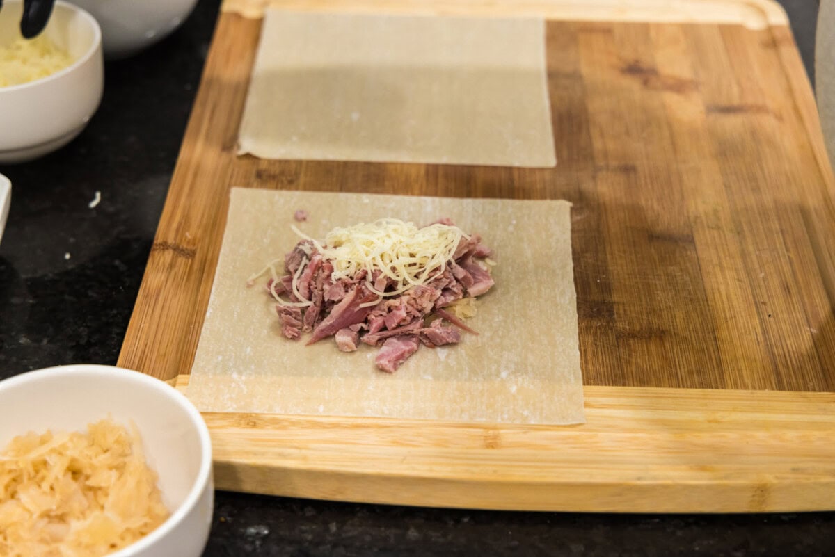 egg roll wrapper with corned beef and shredded swiss cheese