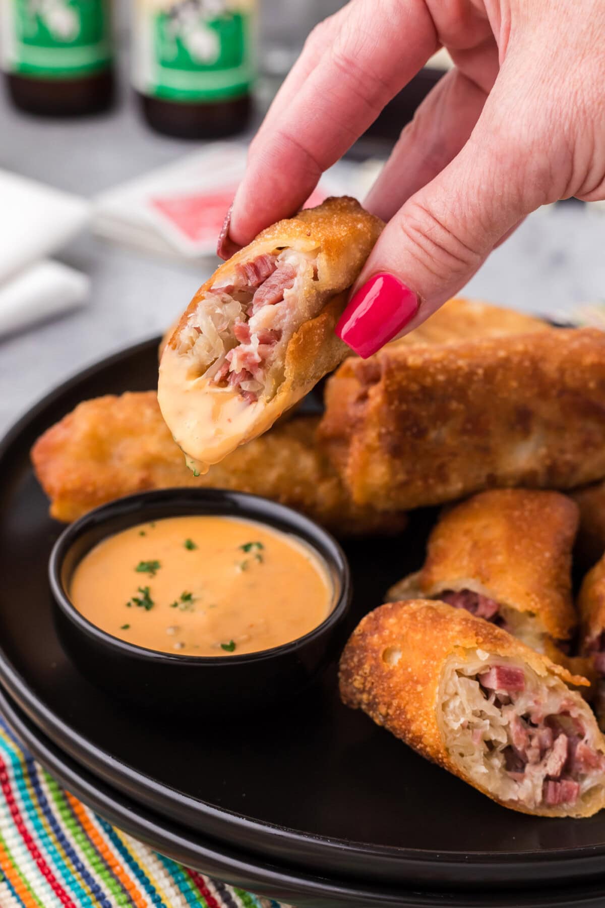 Half of a Reuben Egg Roll dipped in thousand island dressing