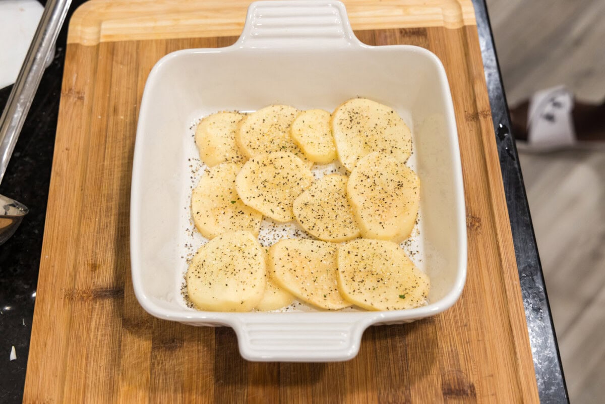 layer of sliced potatoes in a dish