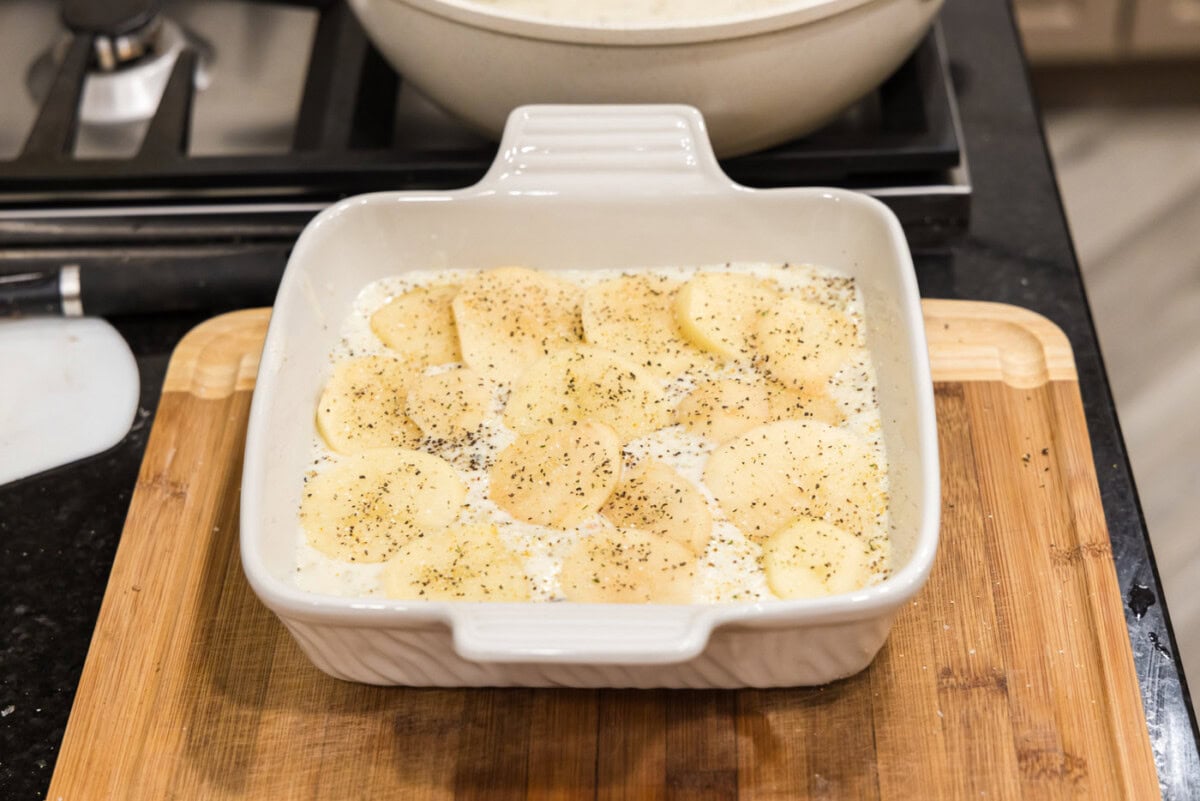 cream sauce over sliced potatoes