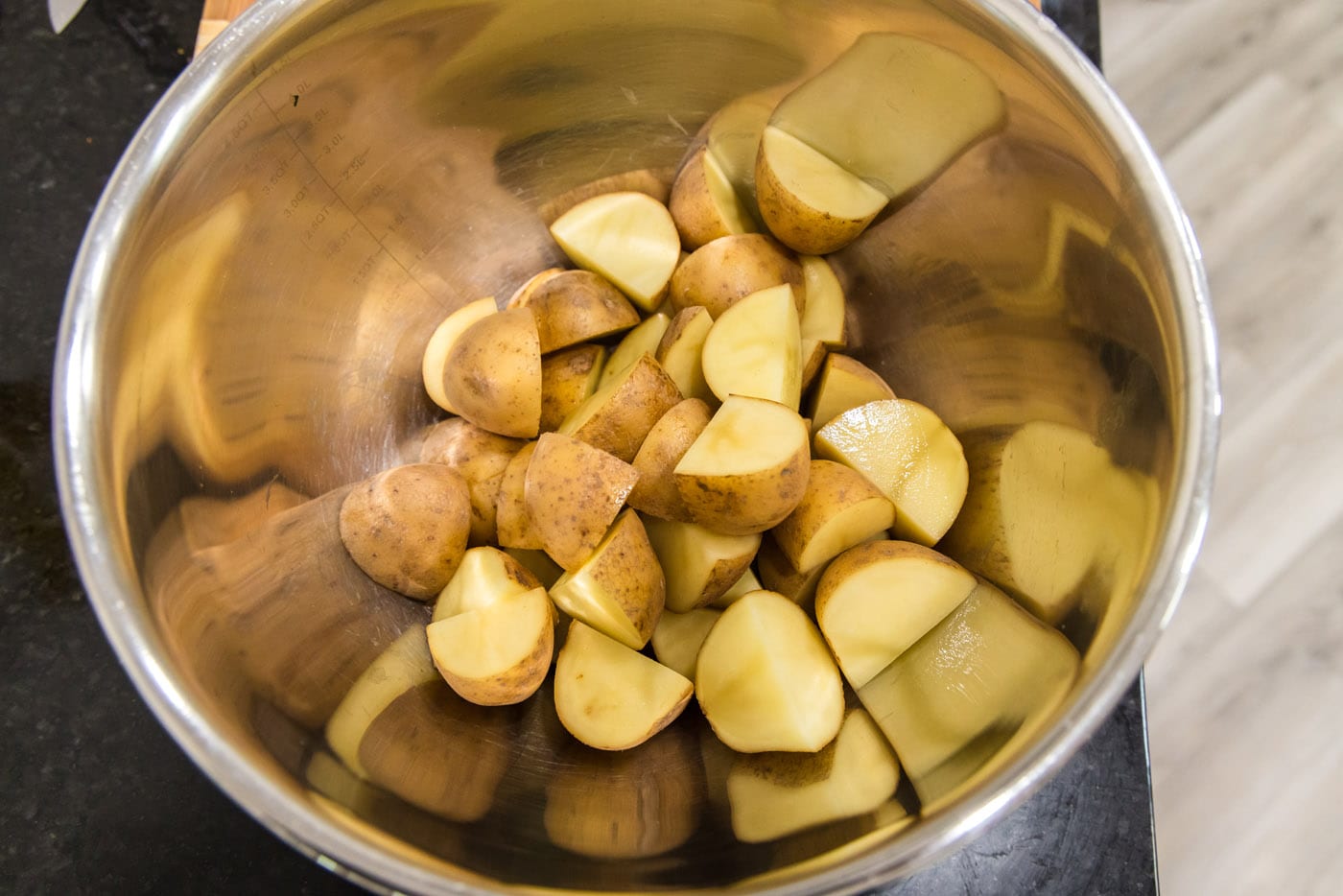 quartered yukon gold potatoes in a mixing bowl