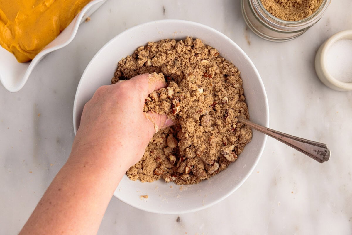 crumbling butter into pecan streusel topping