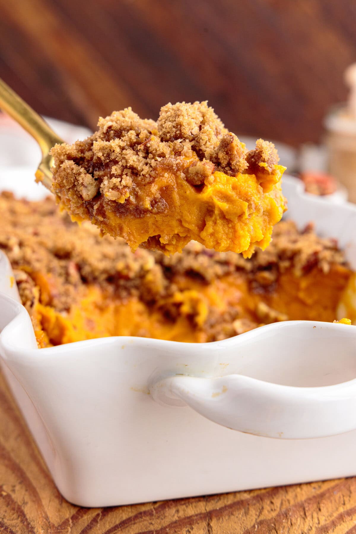 Spoonful of Sweet Potato Souffle being lifted out of the baking dish