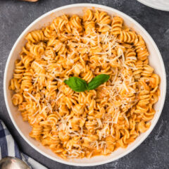Overhead photo of a bowl of pasta covered in Vodka Sauce